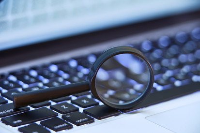Geoexplorer Lupe auf Laptop-Tastatur als Symbol für Suche und Analyse im GeoExplorer.